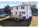 A backyard view featuring an elevated wooden deck, green grass, and a white house exterior at 18 W Academy St, Wendell, NC 27591