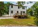 Backyard featuring a large wood deck, white stucco siding, and lush green lawn at 18 W Academy St, Wendell, NC 27591