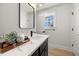 Elegant bathroom featuring a vanity with a marble countertop and stylish fixtures at 18 W Academy St, Wendell, NC 27591