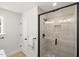 Bright bathroom featuring a modern glass shower, neutral tile, and black hardware accents at 18 W Academy St, Wendell, NC 27591