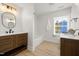 Bright bathroom with dual vanities, and a tub, offers an updated and clean aesthetic at 18 W Academy St, Wendell, NC 27591