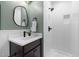 Modern bathroom featuring a sleek vanity, stylish mirror, and a walk-in shower at 18 W Academy St, Wendell, NC 27591