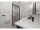 Modern bathroom boasts sleek vanity with stone counter and glass-enclosed shower at 18 W Academy St, Wendell, NC 27591