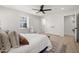 Bright bedroom with white walls, ceiling fan, and closet doors offers serene comfort at 18 W Academy St, Wendell, NC 27591