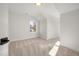 Neutral bedroom offers cozy carpet, natural light, and a tranquil, airy space at 18 W Academy St, Wendell, NC 27591