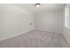 Bright bedroom with neutral carpet, white walls, and a double door closet at 18 W Academy St, Wendell, NC 27591