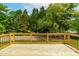 View from the expansive wood deck surrounded by lush trees at 18 W Academy St, Wendell, NC 27591