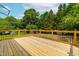 Large wood deck surrounded by trees, offering scenic outdoor entertaining space at 18 W Academy St, Wendell, NC 27591
