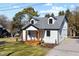 Charming two-story home with white siding, black trim, dormers, and a cozy front porch at 18 W Academy St, Wendell, NC 27591