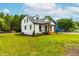 Home's exterior featuring large yard with landscaping and a front porch at 18 W Academy St, Wendell, NC 27591