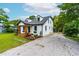Home's exterior featuring stone driveway, front porch, and lovely landscaping at 18 W Academy St, Wendell, NC 27591