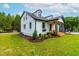 Exterior of home featuring manicured lawn, landscaping, and front porch at 18 W Academy St, Wendell, NC 27591