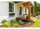 Charming front porch featuring wood columns, flower boxes, and lush landscaping for a welcoming entrance at 18 W Academy St, Wendell, NC 27591