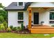 Beautifully landscaped home with a covered front porch, flower boxes, and natural wood accents at 18 W Academy St, Wendell, NC 27591