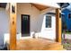 Inviting front porch with wooden deck, elegant door, stylish lighting, and potted plants at 18 W Academy St, Wendell, NC 27591