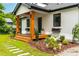 Inviting front porch with wooden columns, black-framed windows, and colorful flower accents enhancing curb appeal at 18 W Academy St, Wendell, NC 27591