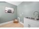 Clean laundry room features a sink, utility hook-ups, and decorative wall art at 18 W Academy St, Wendell, NC 27591