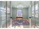 Stylish office with a modern desk, elegant chandelier, and plenty of natural light at 18 W Academy St, Wendell, NC 27591