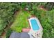 Aerial shot of a beautiful yard with mature trees, in-ground pool, and swing set on a large lot at 1817 Foxbrook Dr, Raleigh, NC 27603