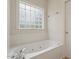 Relaxing white bathroom features a soaking tub and tile accents at 1817 Foxbrook Dr, Raleigh, NC 27603