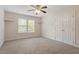 Neutral bedroom with carpet, double door closet, and bright window views at 1817 Foxbrook Dr, Raleigh, NC 27603