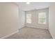 Well-lit bedroom with large windows, neutral walls and carpeted floor at 1817 Foxbrook Dr, Raleigh, NC 27603