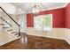 Elegant dining area featuring hardwood floors, stylish lighting, and access to the staircase at 1817 Foxbrook Dr, Raleigh, NC 27603