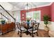 Cozy dining room with a round table, statement chandelier, and large windows at 1817 Foxbrook Dr, Raleigh, NC 27603