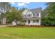 Beautiful two-story home featuring a cozy front porch and meticulously landscaped lawn at 1817 Foxbrook Dr, Raleigh, NC 27603