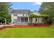 Back of house with large yard, porch, and cozy outdoor seating area at 1817 Foxbrook Dr, Raleigh, NC 27603