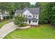 Beautiful two-story home with a well-manicured lawn, mature tree, black shutters and a front porch at 1817 Foxbrook Dr, Raleigh, NC 27603