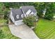 A charming two-story home with an attached garage, manicured lawn, and mature trees around the perimeter at 1817 Foxbrook Dr, Raleigh, NC 27603