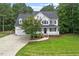 Charming two-story white home with black shutters, attached garage, and well-maintained landscaping at 1817 Foxbrook Dr, Raleigh, NC 27603