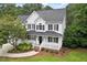 Charming two-story home featuring a welcoming front porch and well-manicured landscaping at 1817 Foxbrook Dr, Raleigh, NC 27603