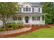 Inviting front of home with a covered porch, lovely landscaping, and sidewalk at 1817 Foxbrook Dr, Raleigh, NC 27603
