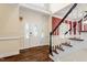 Elegant foyer showcasing beautiful hardwood floors and a staircase with detailed trim at 1817 Foxbrook Dr, Raleigh, NC 27603