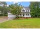 Traditional two-story home with a well-manicured lawn and beautiful landscaping at 1817 Foxbrook Dr, Raleigh, NC 27603