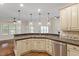 Bright kitchen with peninsula island, stainless appliances, and modern lighting at 1817 Foxbrook Dr, Raleigh, NC 27603