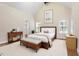 Inviting main bedroom with a large bed, side tables, ensuite bath and natural light at 1817 Foxbrook Dr, Raleigh, NC 27603