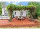 Back patio with seating area under beautiful pergola covered with lush vines at 1817 Foxbrook Dr, Raleigh, NC 27603