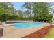 A serene pool with diving board surrounded by lush greenery, ideal for relaxation and recreation at 1817 Foxbrook Dr, Raleigh, NC 27603