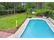 Large in-ground pool with diving board, concrete pool deck, and green space; perfect for outdoor fun at 1817 Foxbrook Dr, Raleigh, NC 27603