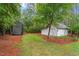 Two storage sheds nestled in a wooded area, offering ample space for tools, equipment, and outdoor gear at 1817 Foxbrook Dr, Raleigh, NC 27603