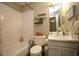 Well-lit bathroom featuring a shower/tub combo, vanity, and white tile at 1910 Trexler Ct, Raleigh, NC 27606