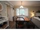 Comfortable dining area with a wooden table, bench seating, and plenty of natural light at 1910 Trexler Ct, Raleigh, NC 27606