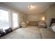 Spacious living room featuring a large sofa, natural light, and comfortable seating at 1910 Trexler Ct, Raleigh, NC 27606