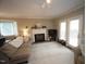 Cozy living room with fireplace, neutral carpet, and french doors to patio at 1910 Trexler Ct, Raleigh, NC 27606