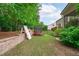 Landscaped backyard featuring a playground, trampoline, and well-maintained lawn at 1939 Mostyn Ln, Apex, NC 27502