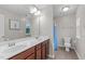 Bright bathroom with a double vanity, tile floors, and a tub/shower combo at 1939 Mostyn Ln, Apex, NC 27502
