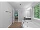Bright bathroom features a soaking tub and is adjacent to the bedroom at 1939 Mostyn Ln, Apex, NC 27502